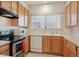 Well-lit kitchen featuring wooden cabinets, essential appliances, and a clean aesthetic for efficient cooking at 4385 S Balsam St # 3-101, Littleton, CO 80123