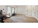 Spacious living room with natural light, neutral carpet and a tiled entry, creating a warm and inviting atmosphere at 4385 S Balsam St # 3-101, Littleton, CO 80123
