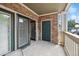Private covered patio with stone accents, an entry door, and sliding glass doors for indoor/outdoor living at 4385 S Balsam St # 3-101, Littleton, CO 80123