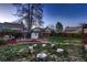 Spacious backyard with mature trees and a cozy space, perfect for enjoying the outdoors at 10321 W 101St Pl, Broomfield, CO 80021