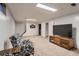 Finished basement area with a TV setup and light walls and carpet at 10321 W 101St Pl, Broomfield, CO 80021