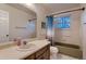 Well-lit bathroom with a vanity, sink, and shower/tub combo, offering a functional design at 10321 W 101St Pl, Broomfield, CO 80021