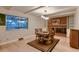 Dining room featuring a brick fireplace, large window, and hardwood floors at 10321 W 101St Pl, Broomfield, CO 80021