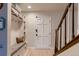 Entryway with coat storage, bench, and a staircase leading to the upper level at 10321 W 101St Pl, Broomfield, CO 80021