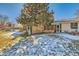 Landscaped backyard with snow, screened porch and trees at 246 S 22Nd Ave, Brighton, CO 80601