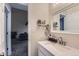 Cozy bathroom featuring modern fixtures, a sink, and a view to an adjoining room at 246 S 22Nd Ave, Brighton, CO 80601