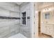 Clean bathroom with tiled shower, built-in shelves, and vanity at 246 S 22Nd Ave, Brighton, CO 80601