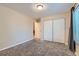 Bright bedroom features a window, carpeting, and a large closet with sliding doors at 246 S 22Nd Ave, Brighton, CO 80601