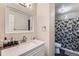 Bathroom with vanity, stylish mirror, and shower with decorative floral curtain at 246 S 22Nd Ave, Brighton, CO 80601