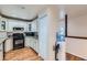 Well-lit kitchen features classic cabinetry and modern black appliances on hardwood floors at 246 S 22Nd Ave, Brighton, CO 80601