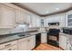 Kitchen featuring ample cabinetry, granite counters, and modern black appliances at 246 S 22Nd Ave, Brighton, CO 80601