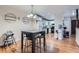 Open concept dining room adjacent to the kitchen, featuring hardwood flooring and contemporary lighting at 246 S 22Nd Ave, Brighton, CO 80601