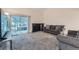 Cozy living room with fireplace, plush carpeting, and sliding door access to an enclosed patio at 246 S 22Nd Ave, Brighton, CO 80601