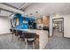 Modern community kitchen with granite countertops and bar seating at 3131 E Alameda Ave # 2002, Denver, CO 80209