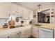 Well-equipped kitchen with white cabinets and tiled backsplash at 3131 E Alameda Ave # 2002, Denver, CO 80209