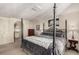 Main bedroom with a post bed and ensuite access at 3131 E Alameda Ave # 2002, Denver, CO 80209