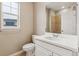 Well-lit bathroom features a white vanity, toilet, and a tiled shower with glass door at 39751 Congress Ln, Elizabeth, CO 80107