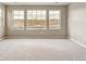 Large bedroom with neutral carpeting, large windows with views of the neighborhood at 39751 Congress Ln, Elizabeth, CO 80107