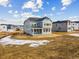 New two-story home with blue siding, dark roof, large windows, and unfinished front yard at 39751 Congress Ln, Elizabeth, CO 80107