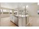 Kitchen island features stainless dishwasher, white cabinets and countertops, with backyard views at 39751 Congress Ln, Elizabeth, CO 80107