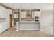 Stylish kitchen with white cabinets, stainless appliances, tile backsplash, and hardwood floors at 39751 Congress Ln, Elizabeth, CO 80107