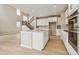 Open-concept kitchen with white cabinets, stainless steel appliances, and hardwood floors at 39751 Congress Ln, Elizabeth, CO 80107