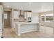 Bright, open kitchen featuring white cabinets, stainless hood, and spacious central island at 39751 Congress Ln, Elizabeth, CO 80107
