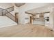 Bright, open-concept living room with hardwood floors, staircase, and modern finishes at 39751 Congress Ln, Elizabeth, CO 80107