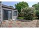 Exterior view showcasing the back of the house with a tiled patio and mature landscaping at 11186 E Baltic Dr, Aurora, CO 80014