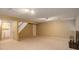 Basement with neutral carpet, a kitchenette and fireplace, offering great potential for customization at 11186 E Baltic Dr, Aurora, CO 80014