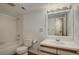 Bright bathroom with a tiled shower-tub combination, toilet, and vanity with a large mirror at 11186 E Baltic Dr, Aurora, CO 80014