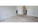 A spacious bedroom with neutral carpet and a view into the hallway is shown at 11186 E Baltic Dr, Aurora, CO 80014