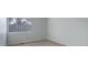 A bright bedroom with neutral carpet and a large window is shown at 11186 E Baltic Dr, Aurora, CO 80014