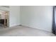 This bedroom is spacious, neutral, and includes a window and a view into the hallway at 11186 E Baltic Dr, Aurora, CO 80014
