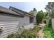 Exterior home view, featuring well-maintained siding, brick pathway, and garden with roses at 11186 E Baltic Dr, Aurora, CO 80014