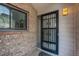 Inviting front entry featuring a secure iron gate, brick accents, and a stylish exterior light fixture at 11186 E Baltic Dr, Aurora, CO 80014