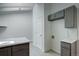 A bright kitchen area is shown with gray cabinets and attractive countertops at 11186 E Baltic Dr, Aurora, CO 80014