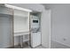 A stackable washer and dryer unit is featured in this closet with built-in shelving and closet space at 11186 E Baltic Dr, Aurora, CO 80014