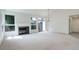 Spacious living room with large windows, a cozy fireplace, and access to outdoor living spaces at 11186 E Baltic Dr, Aurora, CO 80014
