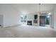 Bright living room features a cozy fireplace, large windows, and sliding glass doors to the backyard at 11186 E Baltic Dr, Aurora, CO 80014