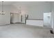 Expansive living room featuring neutral carpet, modern lighting, and access to other areas of the home at 11186 E Baltic Dr, Aurora, CO 80014