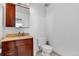 Bathroom features a single sink vanity, framed mirror, and standard white toilet with tile flooring at 2020 Arapahoe St # 1250, Denver, CO 80205