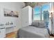 Cozy bedroom with a large window offering city views and a comfortable queen-size bed and adjacent desk at 2020 Arapahoe St # 1250, Denver, CO 80205