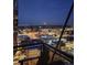 Nighttime balcony view showcasing the city skyline with rooftops and streets in a winter setting at 2020 Arapahoe St # 1250, Denver, CO 80205