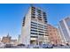 Modern high-rise building with concrete and glass exterior, balconies, and parking garage entrance in downtown Denver at 2020 Arapahoe St # 1250, Denver, CO 80205