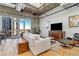 Bright living room features hardwood floors, exposed ductwork, and a large window with city views at 2020 Arapahoe St # 1250, Denver, CO 80205
