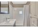 Bathroom featuring white tile, a shower-tub combo, and a modern vanity at 1590 S Milwaukee St, Denver, CO 80210