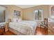 Cozy bedroom featuring wood floors, natural light, and neutral decor with a comfortable queen sized bed at 1590 S Milwaukee St, Denver, CO 80210
