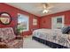 Bedroom with red walls, neutral carpet, queen-sized bed, mirror and natural light at 1590 S Milwaukee St, Denver, CO 80210