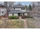 Inviting two-story home featuring a well-manicured lawn and a charming walkway to the front door at 1590 S Milwaukee St, Denver, CO 80210